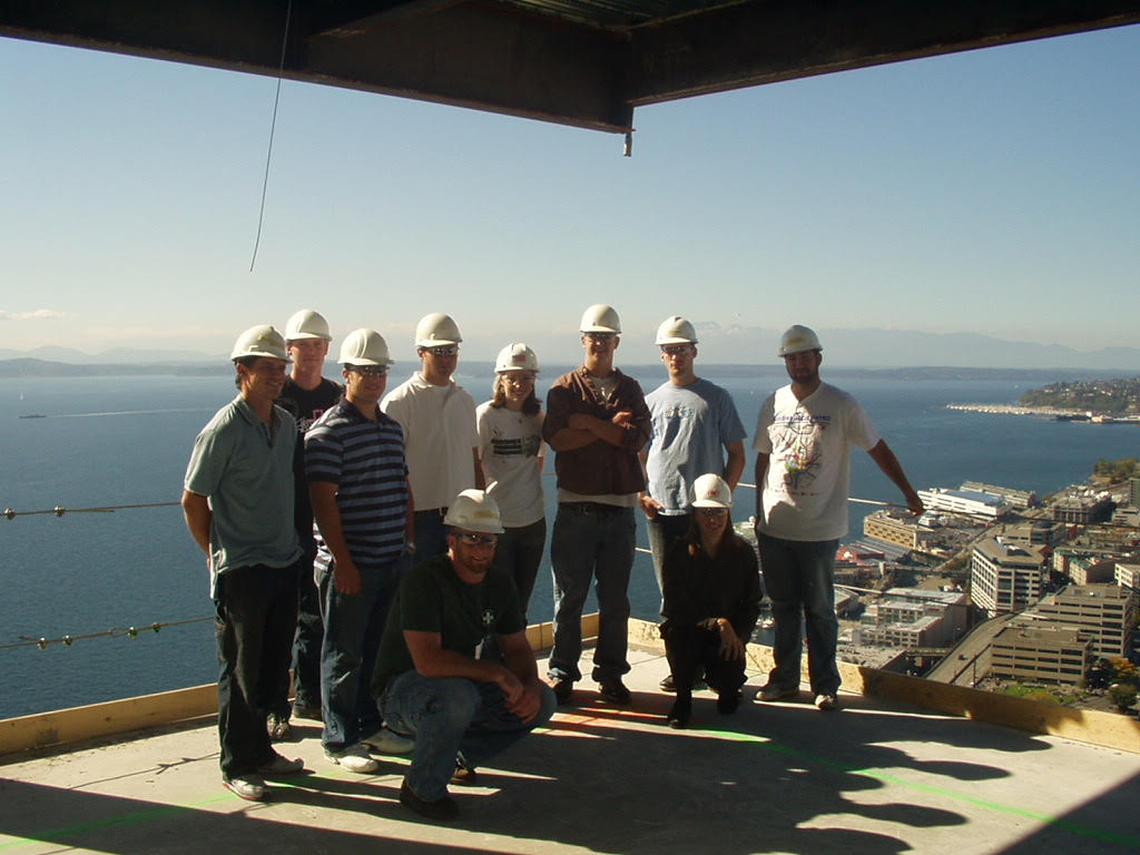Professor Carrie Sturts Dossick and a group of students standing on a building site many stories above ground level.