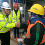 Women in hard hats and construction jackets