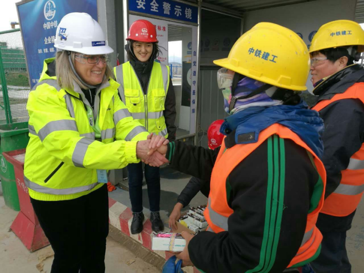 Women in hard hats and construction jackets