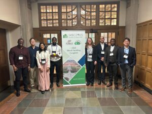 CM faculty and graduate students posing in hallway