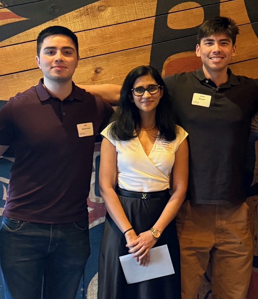 CMAA scholarship recipients standing against a patterned wall