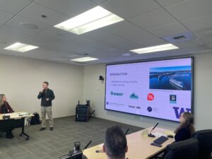 Professor Chris Lee presents in front of a screen with "Introduction" PowerPoint slide.