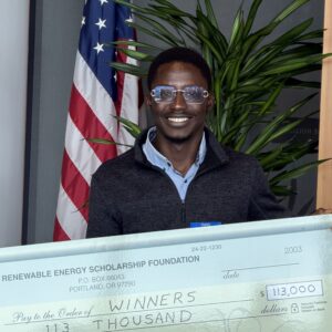 Student holding large scholarship check