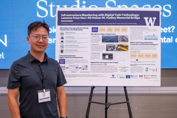 Ori Borjigin standing next to presentation poster